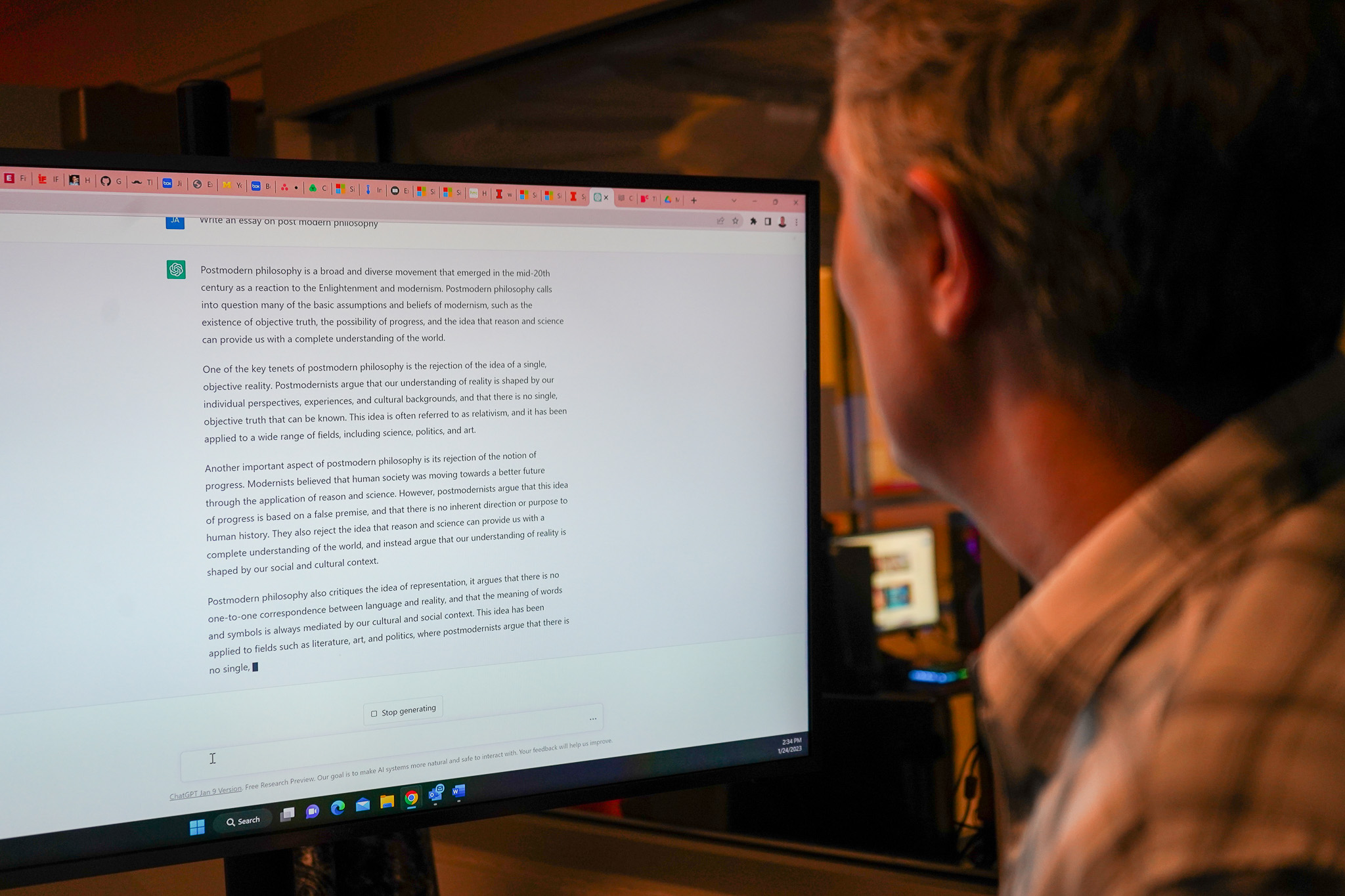 A man watches artificial intelligence write an essay.