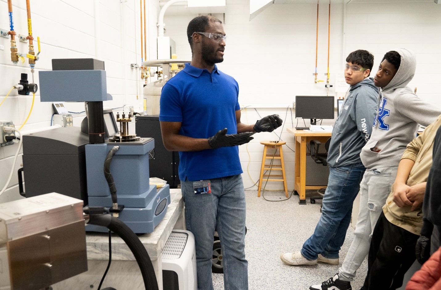 At left, Dr. Roddel Remy explains how the dynamical mechanical analysis tool works. (Photo by Heather Coit).