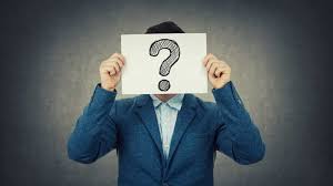 figure holding a question mark sign over their face