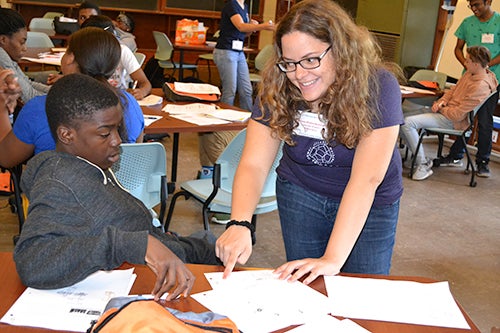 Vanessa Rivera-Quinones, a math Ph.D. student, interacts with a UHS student