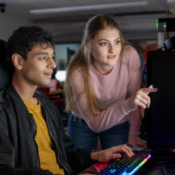 two students looking at a computer monitor