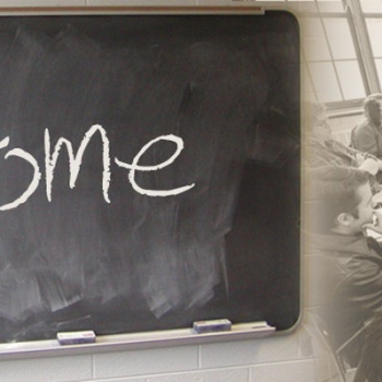 welcome on chalkboard and students at desks sitting in a circle