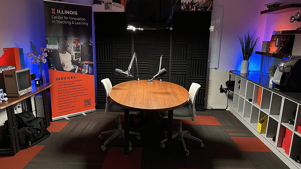Media hub podcast space with table, chairs, and microphones