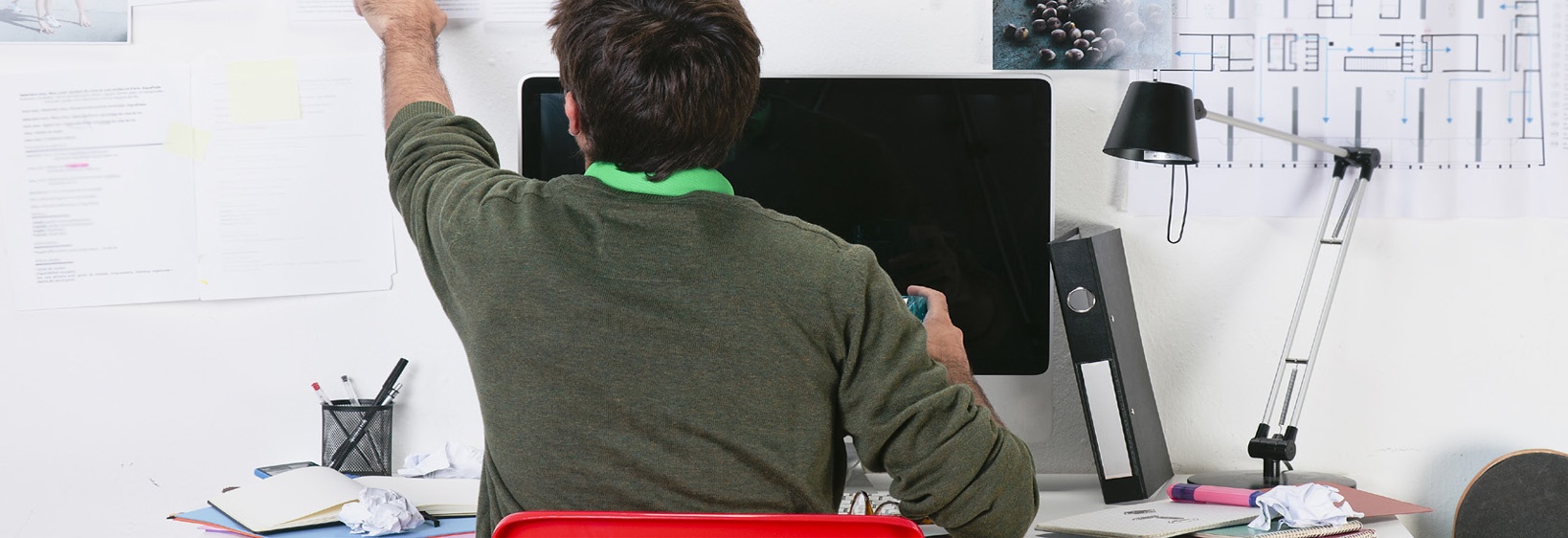 worker sits at a desk in a home office