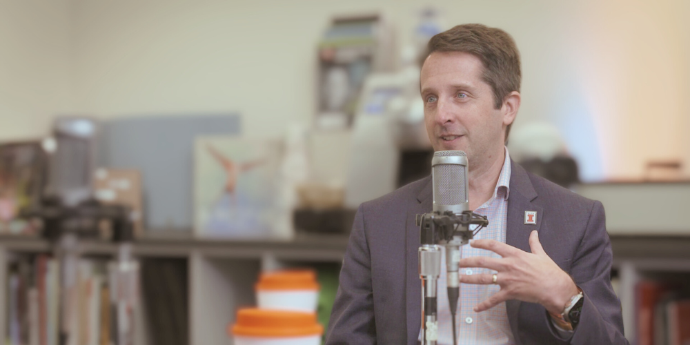 Makela speaking to microphone