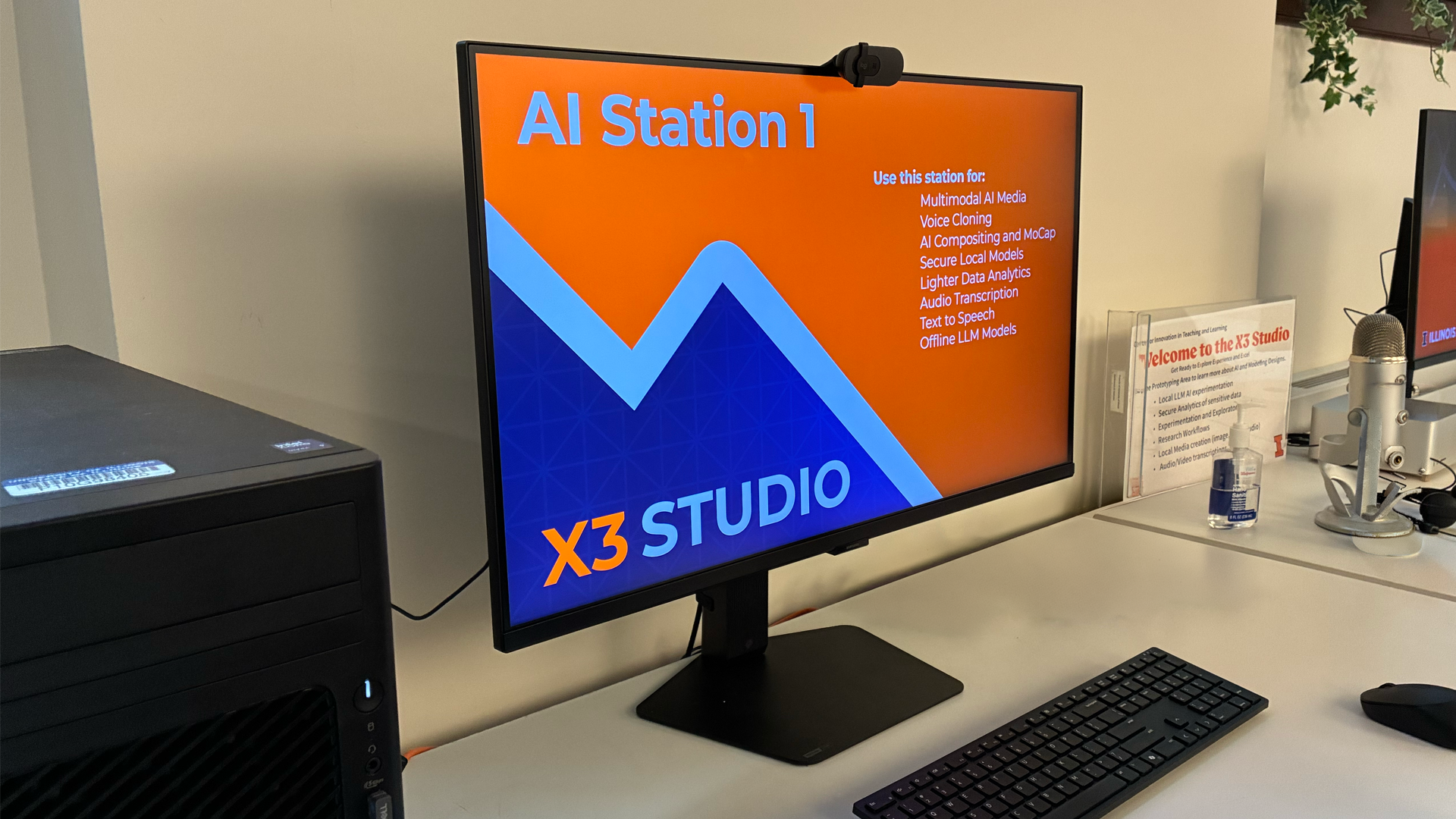 Photo of podcast guests sitting around a table with microphones in X3 Studio